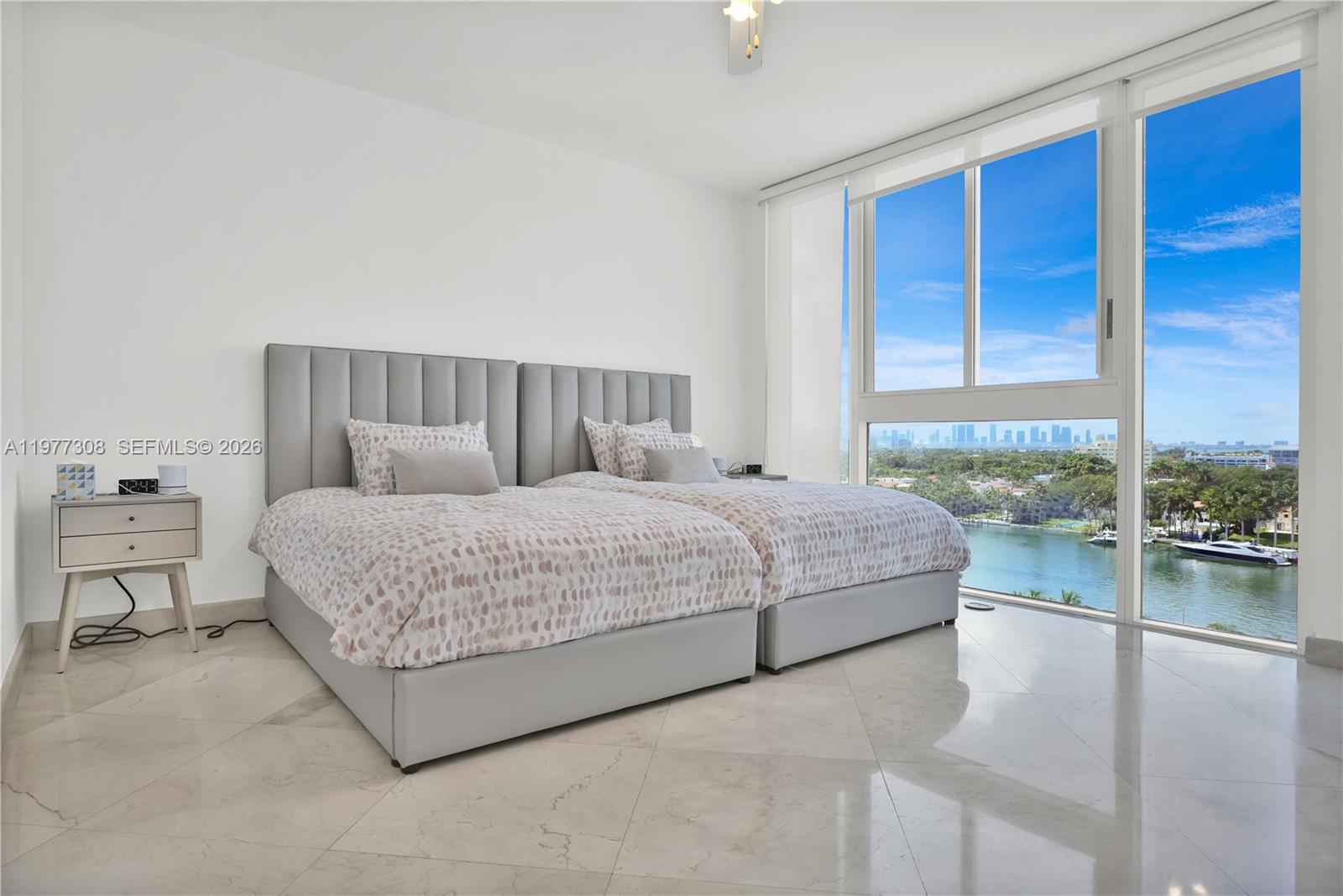 4779 Collins Avenue, Unit 1007 Miami Beach, FL 33140 - Photo 25 of 56 a bedroom with a large bed and a balcony view