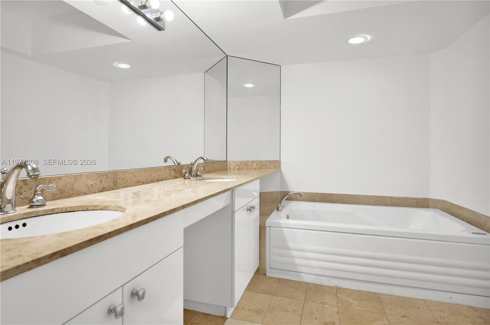 4779 Collins Avenue, Unit 1007 Miami Beach, FL 33140 - Photo 28 of 56 a bathroom with a sink and a bathtub