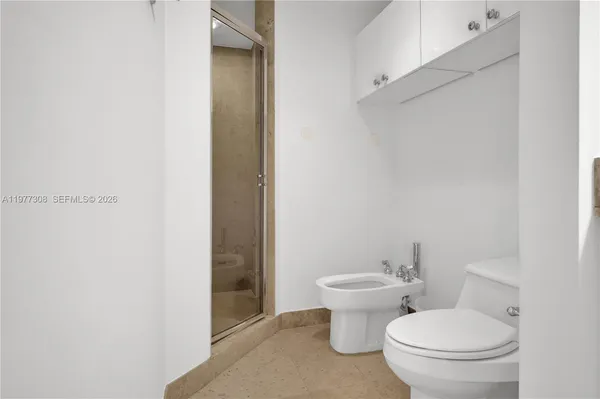 a bathroom with a shower and a glass door