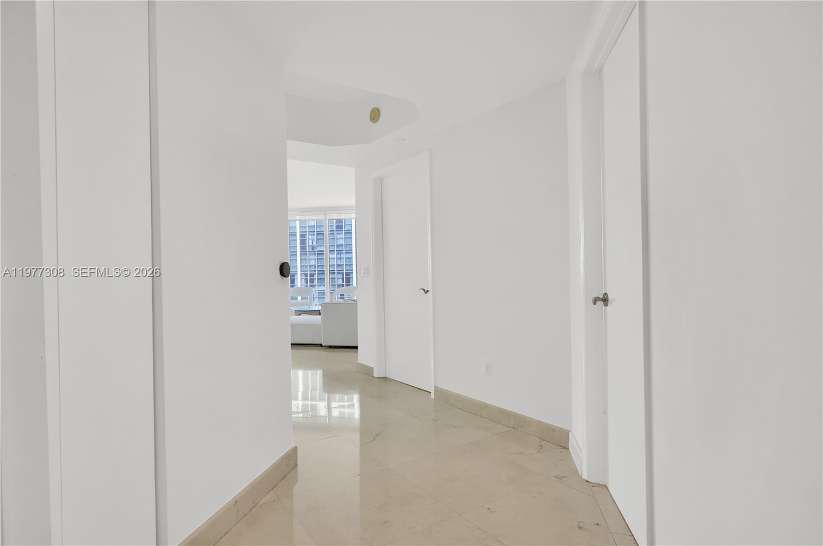 4779 Collins Avenue, Unit 1007 Miami Beach, FL 33140 - Photo 3 of 56 a view of a hallway with wooden shelves