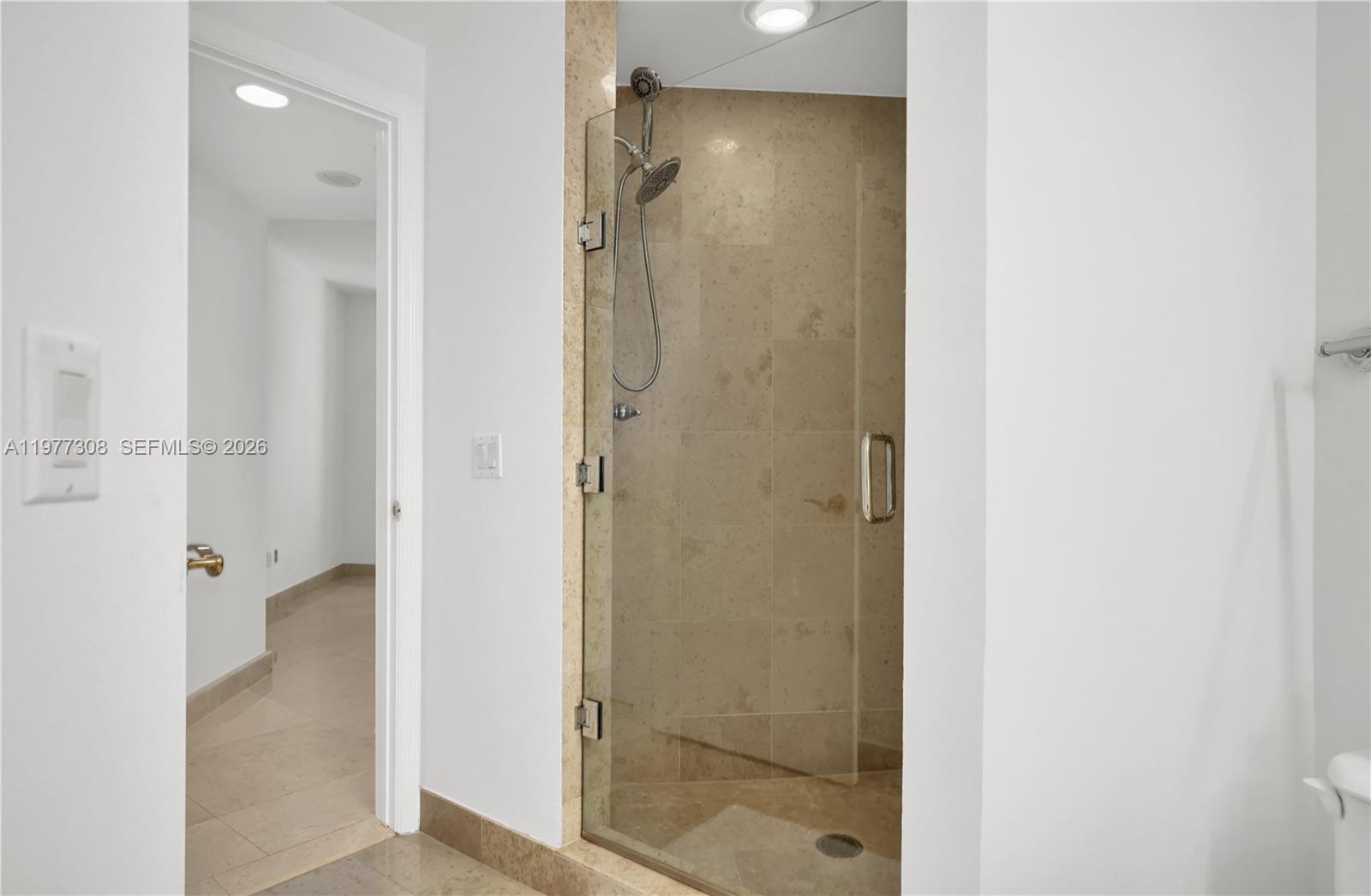 4779 Collins Avenue, Unit 1007 Miami Beach, FL 33140 - Photo 34 of 56 a bathroom with a shower and a glass door