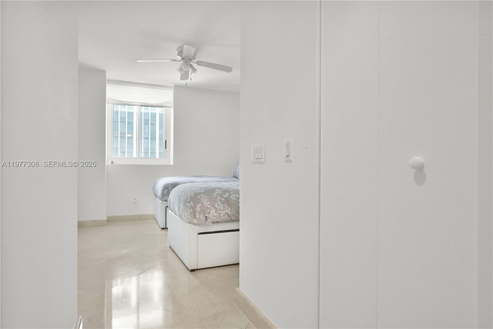 4779 Collins Avenue, Unit 1007 Miami Beach, FL 33140 - Photo 35 of 56 a bedroom with a bed and a window