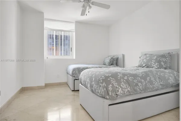 a view of kitchen with stainless steel appliances refrigerator stove dining table and chairs