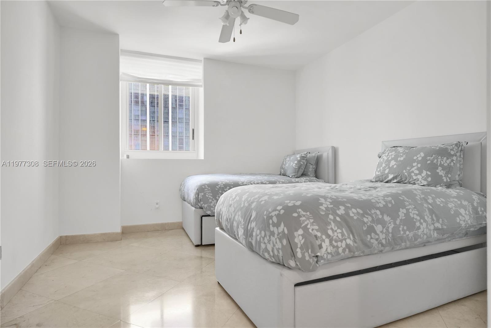 4779 Collins Avenue, Unit 1007 Miami Beach, FL 33140 - Photo 36 of 56 a spacious bedroom with a bed and a window