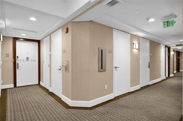 a view of a swimming pool with a lawn chairs and palm tree