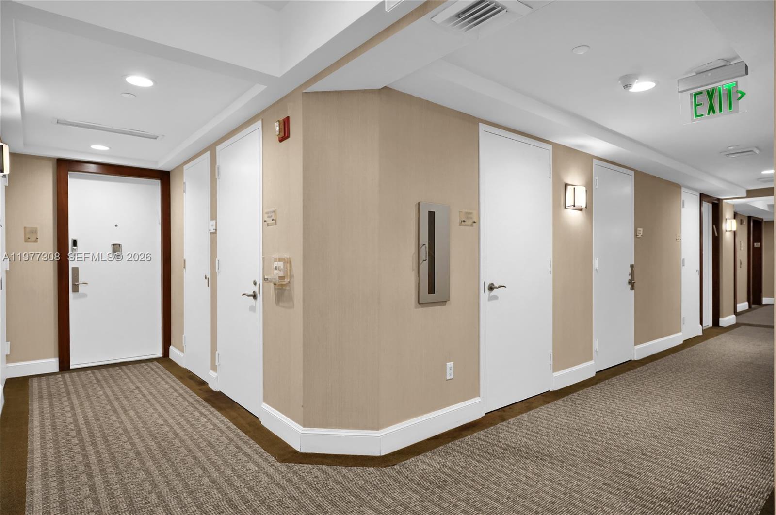 4779 Collins Avenue, Unit 1007 Miami Beach, FL 33140 - Photo 39 of 56 a view of a hallway with wooden floor