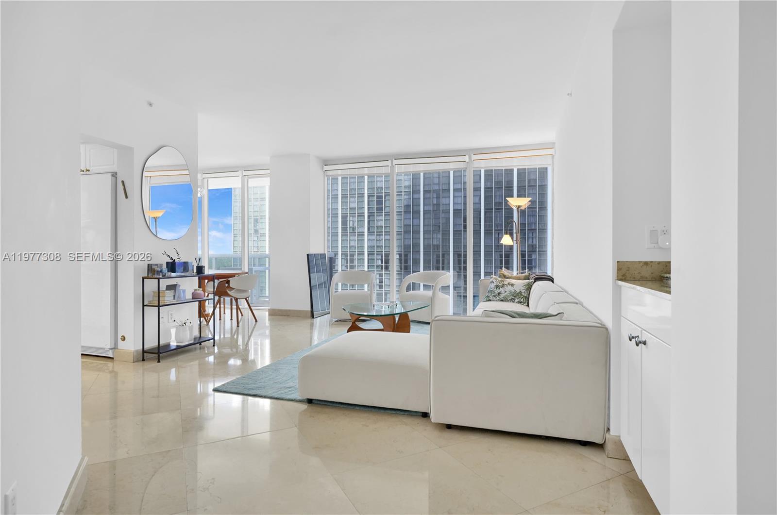 4779 Collins Avenue, Unit 1007 Miami Beach, FL 33140 - Photo 4 of 56 a living room with furniture and a table