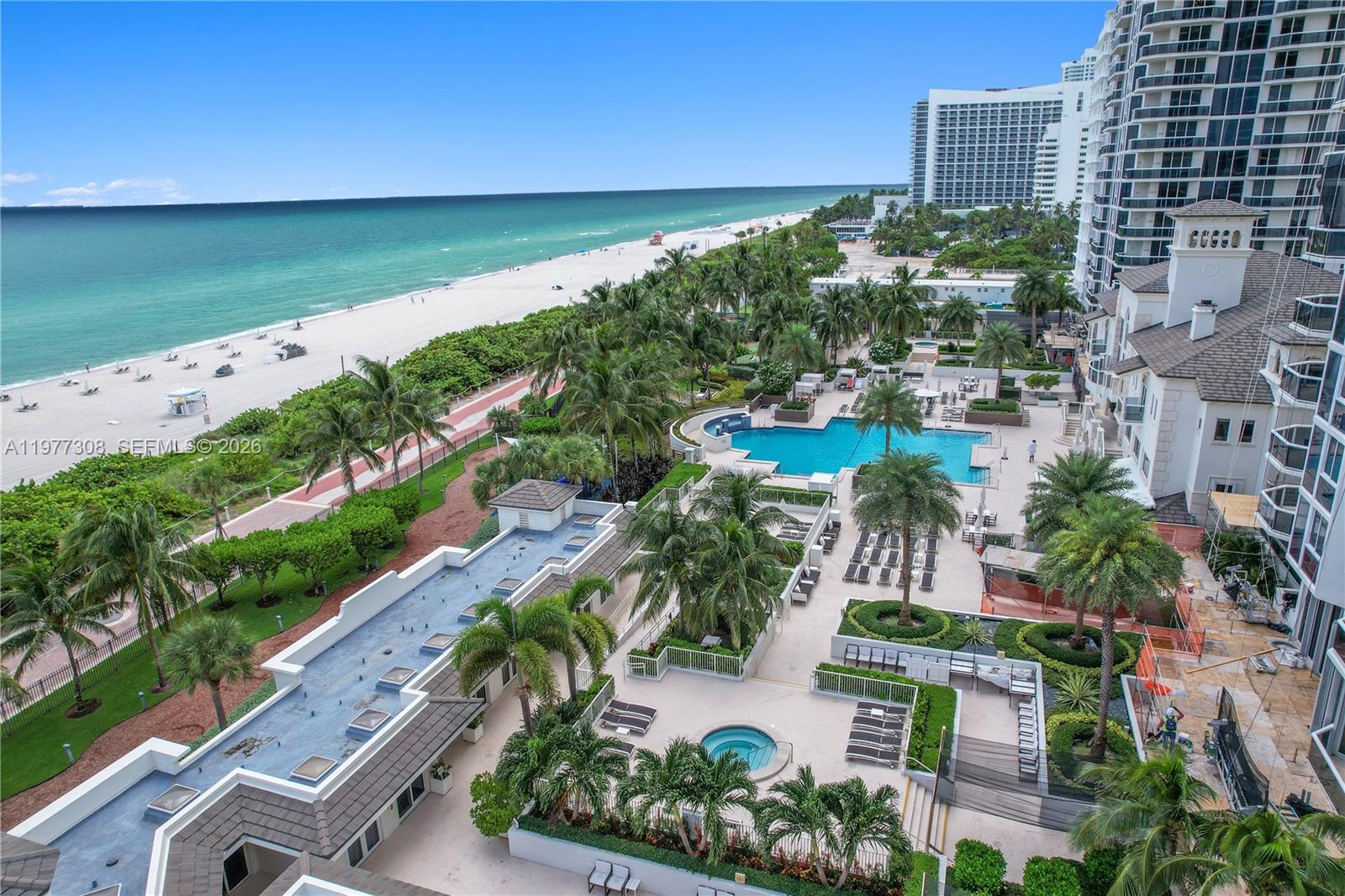 4779 Collins Avenue, Unit 1007 Miami Beach, FL 33140 - Photo 53 of 56 an aerial view of a city with lots of residential buildings ocean and mountain view in back