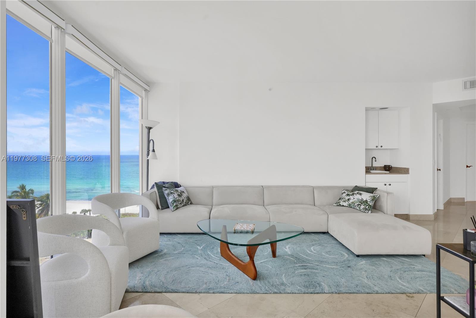 4779 Collins Avenue, Unit 1007 Miami Beach, FL 33140 - Photo 6 of 56 a living room with furniture and a rug