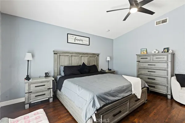 a bedroom with a bed and a ceiling fan