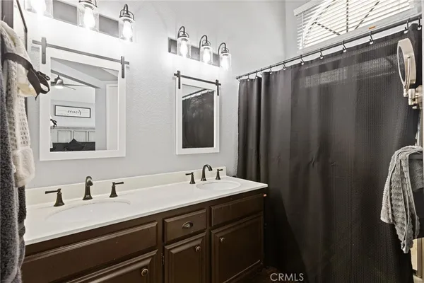 a bathroom with a sink double vanity and mirror
