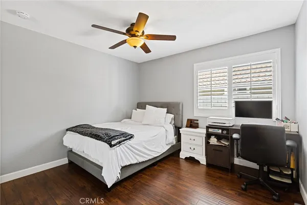 a bedroom with a bed and a desk