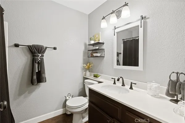 a bathroom with a sink toilet and mirror