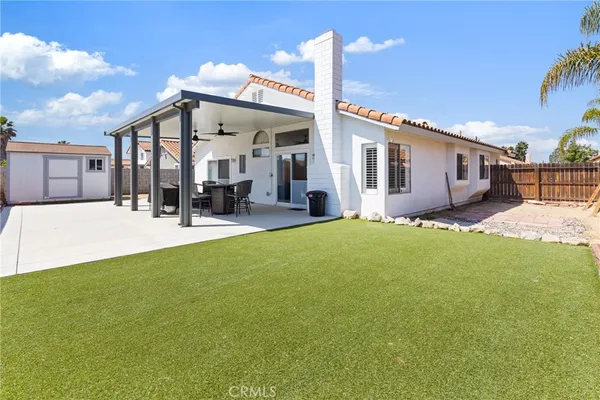 a swimming pool with outdoor seating and yard