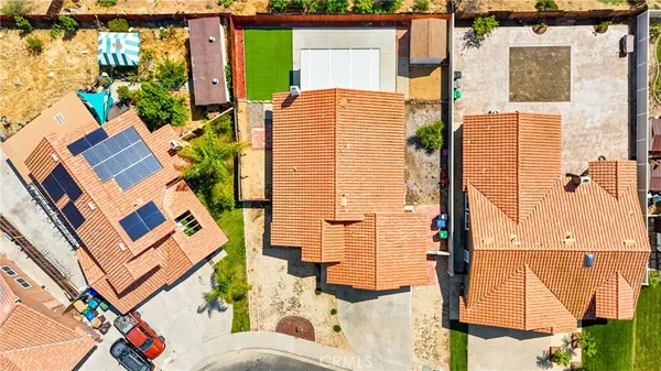 aerial view of a house with a floor to ceiling window and potted plants