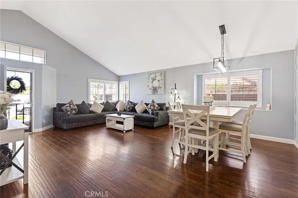 a living room with furniture window and wooden floor