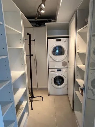 a utility room with sink dryer and washer