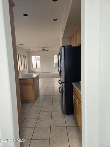 a kitchen with a refrigerator and a stove