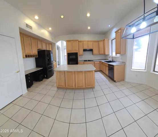 a kitchen with stainless steel appliances a refrigerator sink and microwave