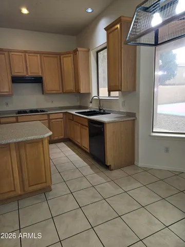 a kitchen with stainless steel appliances granite countertop a sink and a stove