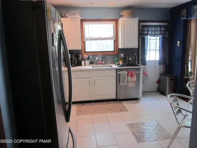 a kitchen with a sink a refrigerator and window