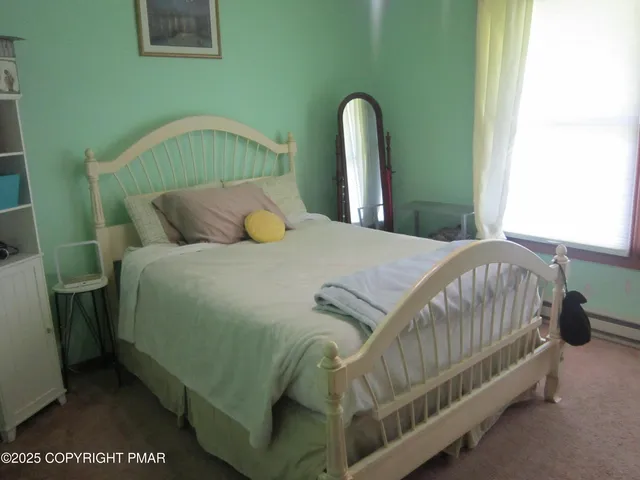 a bedroom with a bed and a mirror