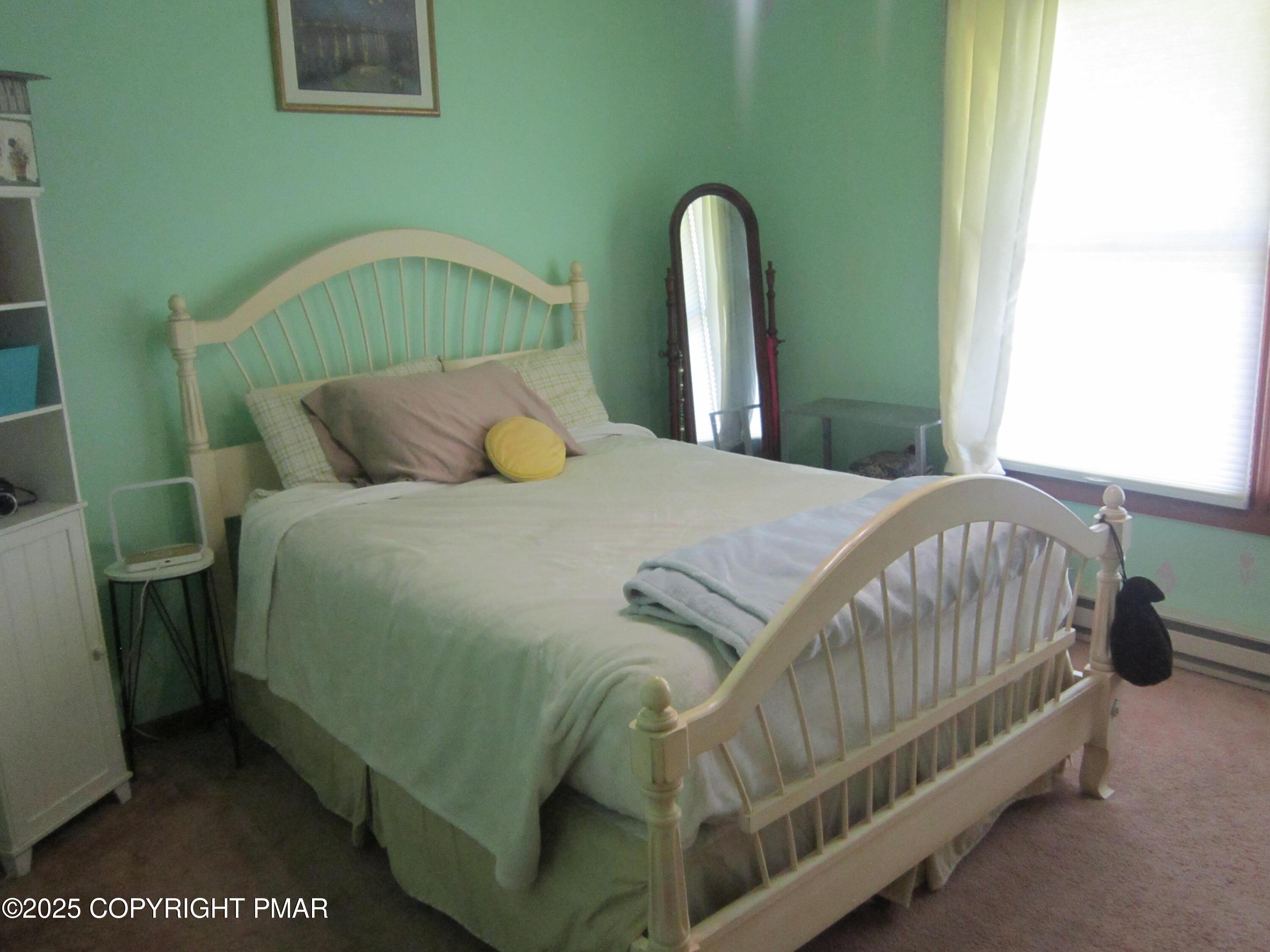 204 Mohican Road Canadensis, PA 18325 - Photo 16 of 20 a bedroom with a bed and a mirror