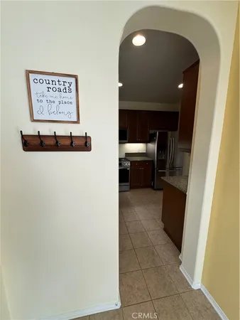 a view of kitchen with sink and refrigerator