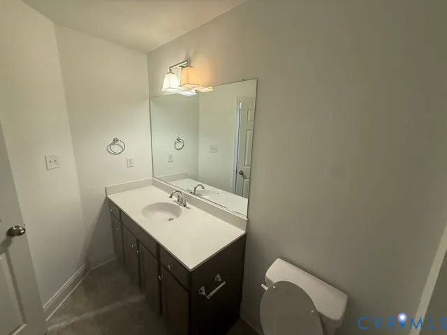 a bathroom with a sink toilet and mirror