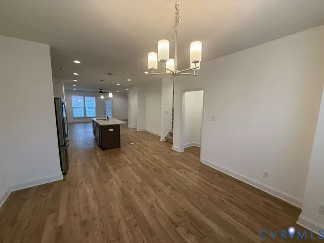 a view of a kitchen with a sink and wooden floor