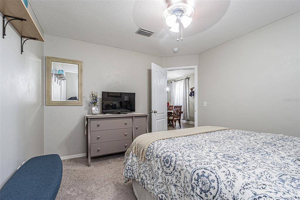 9809 La Rita Place Riverview, FL 33569 - Photo 38 of 59 a bedroom with a bed and a flat screen tv
