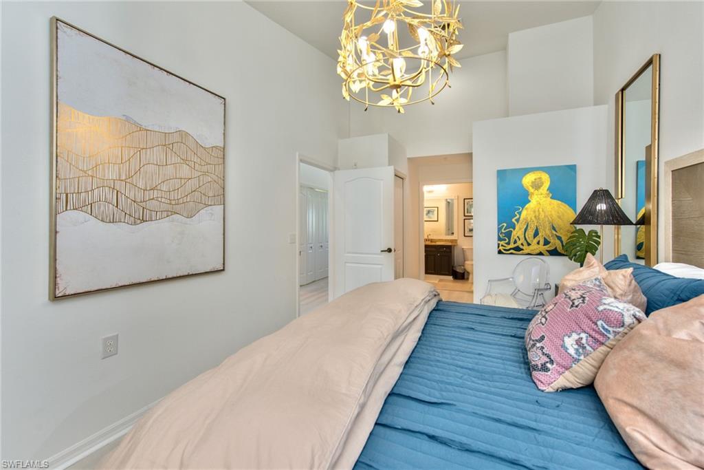 21340 Lancaster Run, Unit 1327 Estero, FL 33928 - Photo 12 of 27 a bedroom with a bed and wooden floor