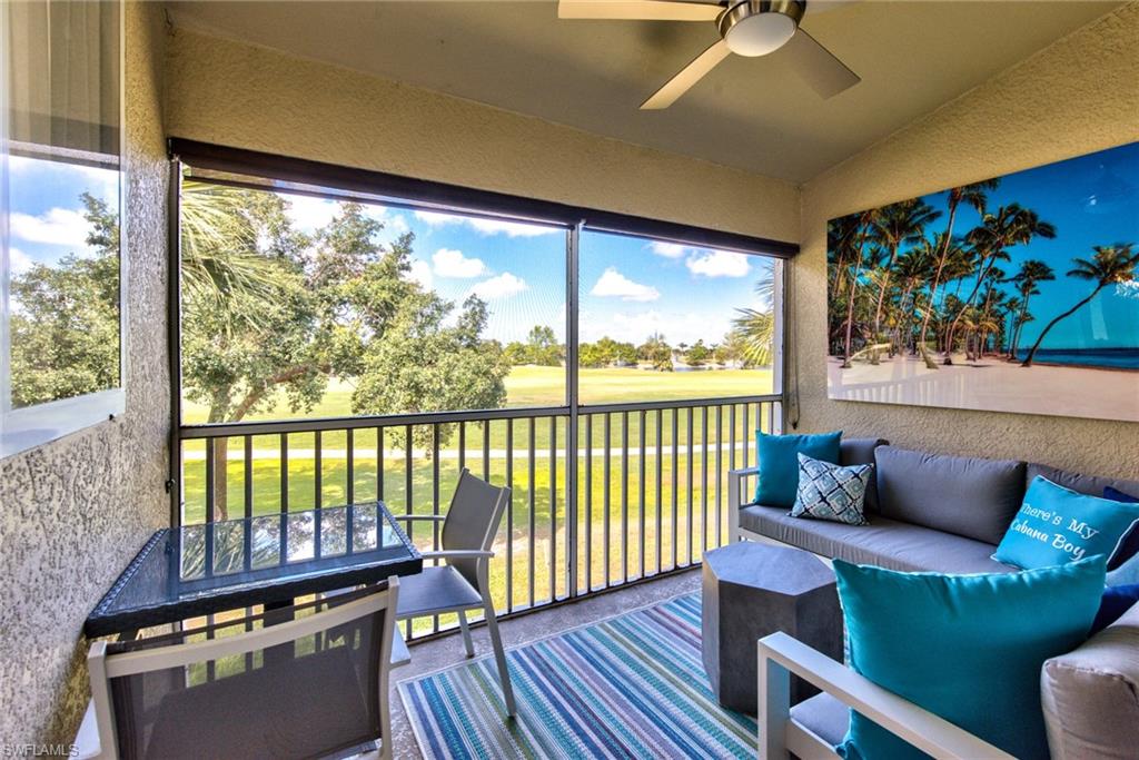 21340 Lancaster Run, Unit 1327 Estero, FL 33928 - Photo 16 of 27 a living room with furniture and a floor to ceiling window