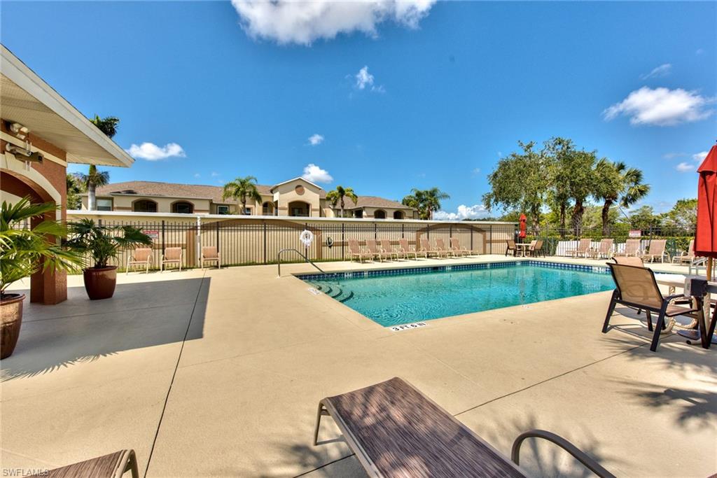 21340 Lancaster Run, Unit 1327 Estero, FL 33928 - Photo 21 of 27 a view of a swimming pool with a patio and a yard