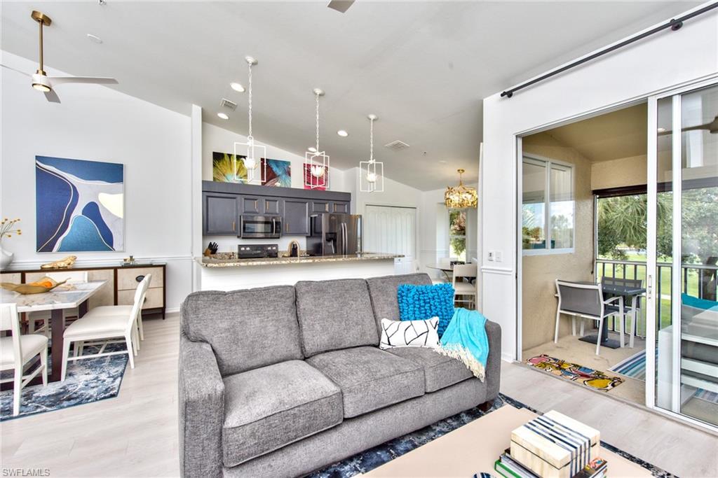 21340 Lancaster Run, Unit 1327 Estero, FL 33928 - Photo 3 of 27 a living room with furniture and a floor to ceiling window