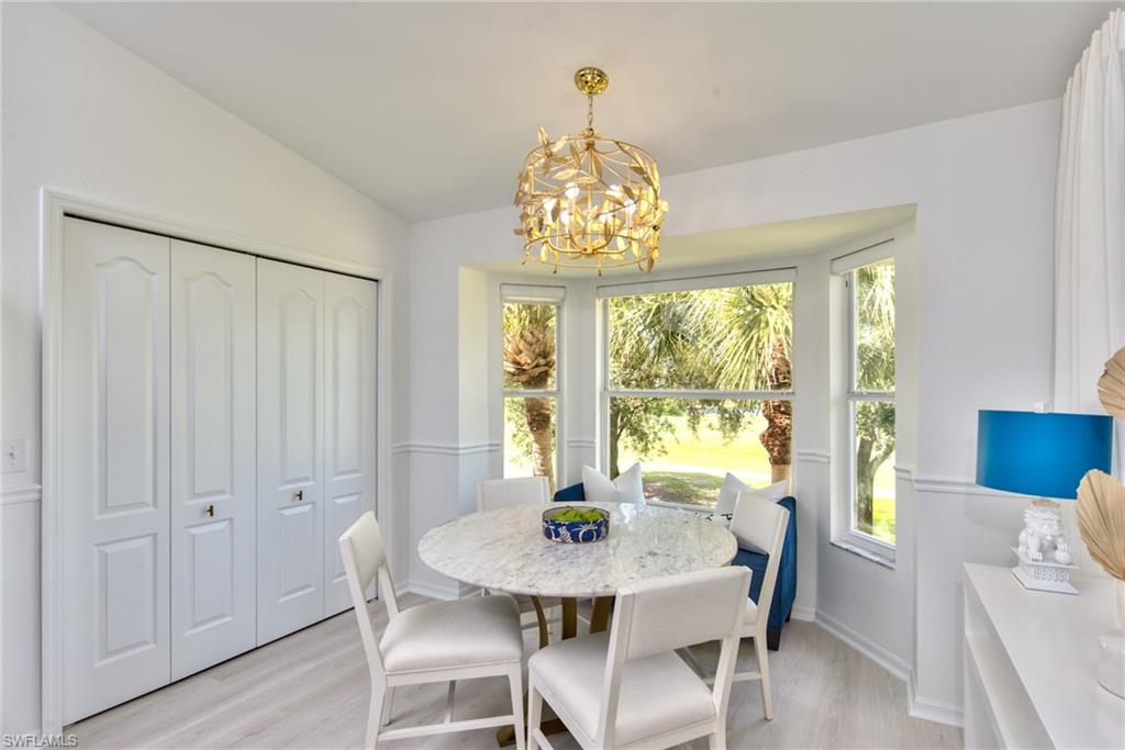 21340 Lancaster Run, Unit 1327 Estero, FL 33928 - Photo 4 of 27 a view of a dining room with furniture window and wooden floor
