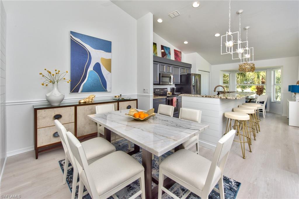 21340 Lancaster Run, Unit 1327 Estero, FL 33928 - Photo 9 of 27 a view of a dining room with furniture and wooden floor