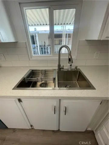 a close view of a sink and dishwasher with kitchen island