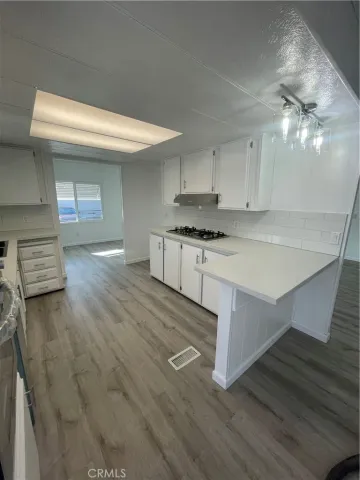 a kitchen with a stove and a refrigerator