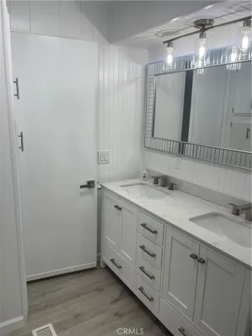 a bathroom with a double vanity sink and mirror