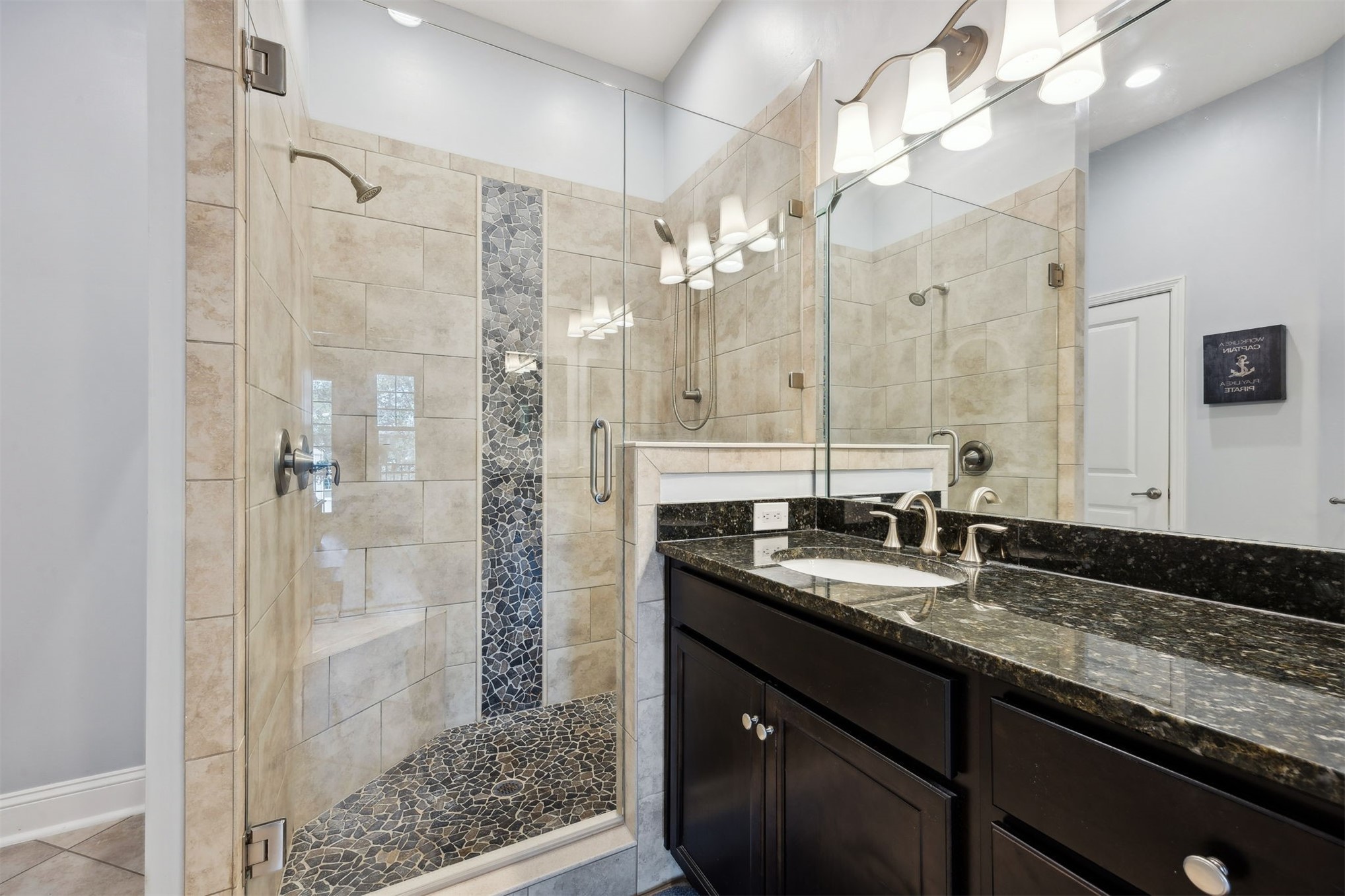 95049 Summer Crossing Road, Unit 1502 Fernandina Beach, FL 32034 - Photo 21 of 61 a bathroom with a granite countertop sink a mirror and shower
