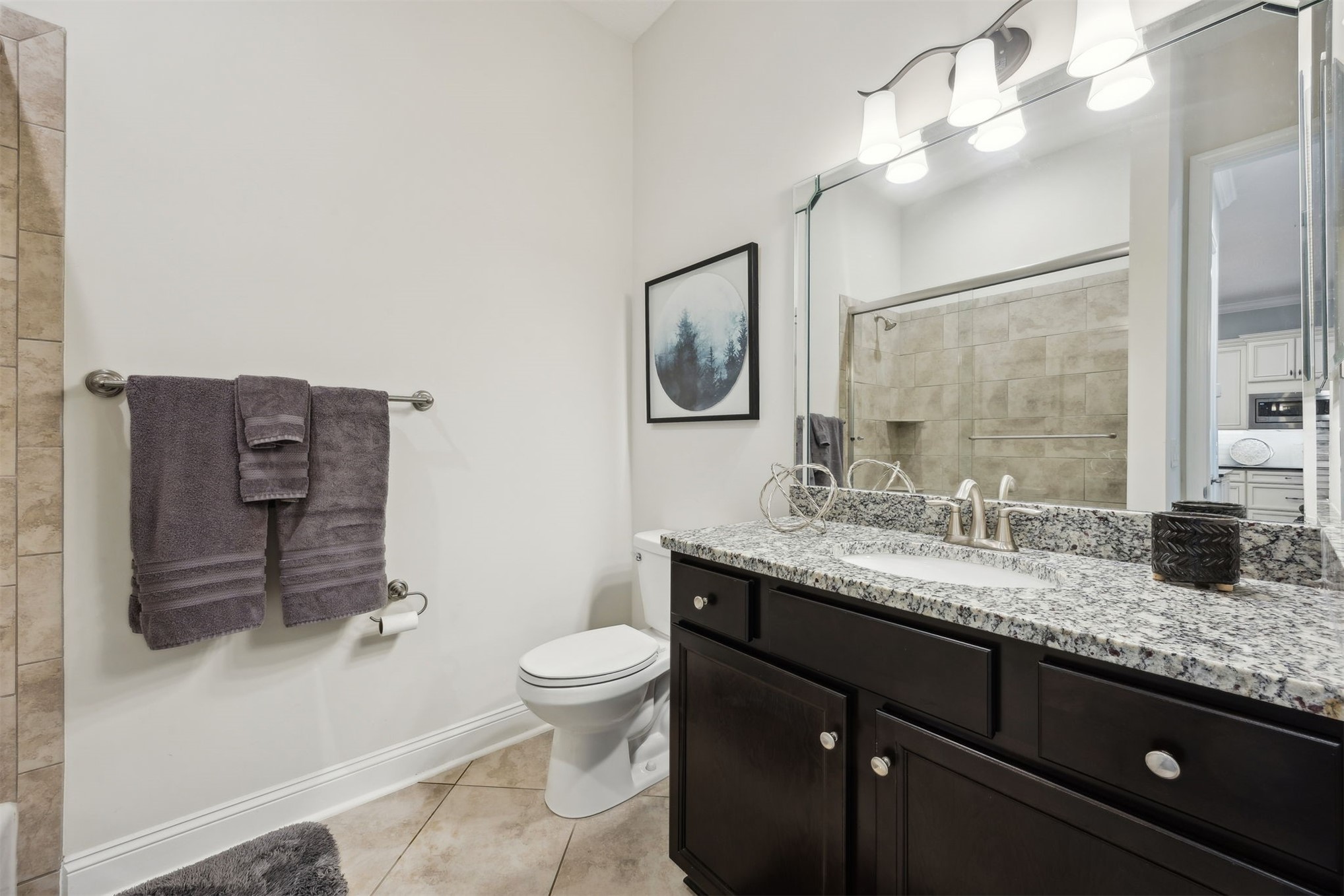95049 Summer Crossing Road, Unit 1502 Fernandina Beach, FL 32034 - Photo 33 of 61 a bathroom with a granite countertop toilet sink and mirror