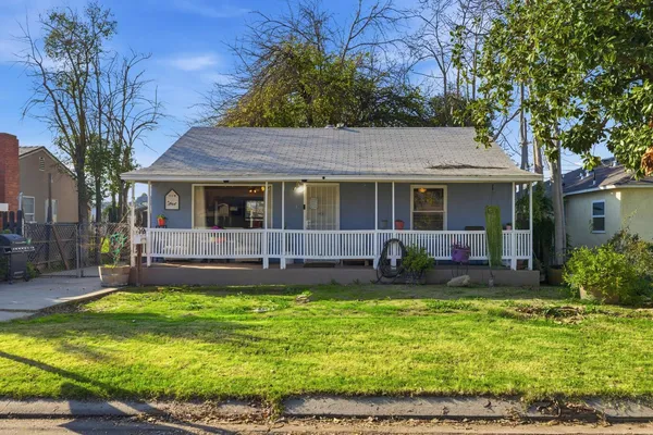 a view of a house with a swimming pool and a yard