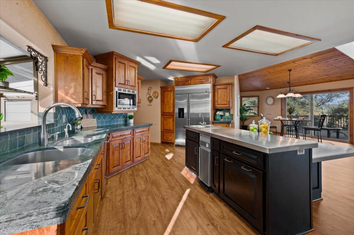 16000 Southridge Road Penn Valley, CA 95946 - Photo 14 of 75 a kitchen with stainless steel appliances granite countertop a stove and a sink