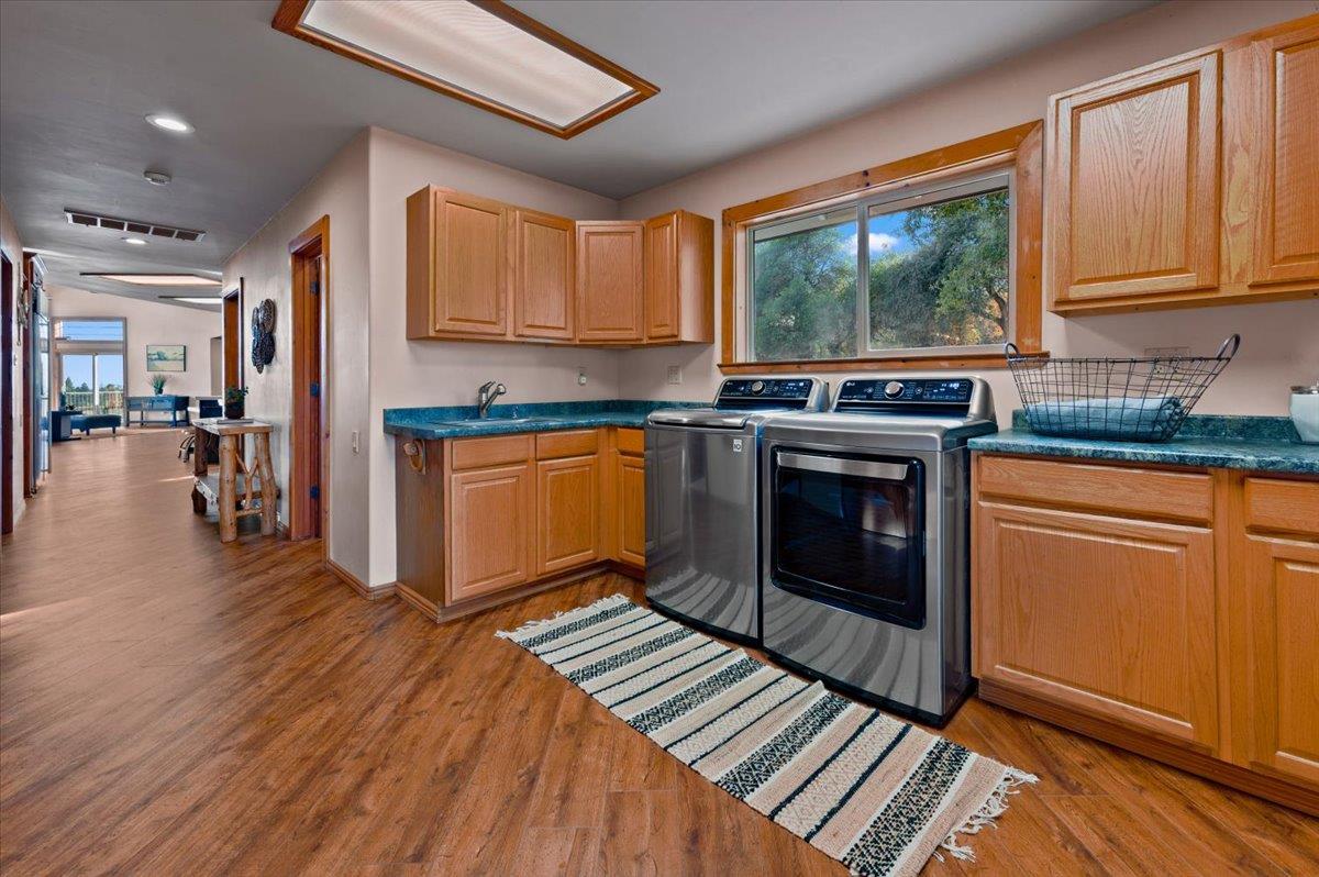16000 Southridge Road Penn Valley, CA 95946 - Photo 18 of 75 a kitchen with stainless steel appliances granite countertop hardwood floor sink stove dining table and chairs