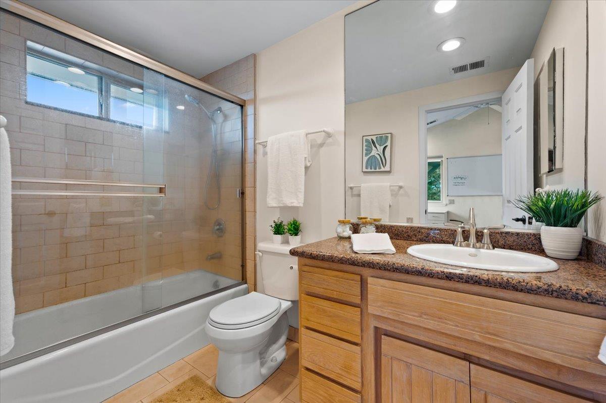 16000 Southridge Road Penn Valley, CA 95946 - Photo 24 of 75 a bathroom with a granite countertop sink a toilet a mirror a bathtub and shower
