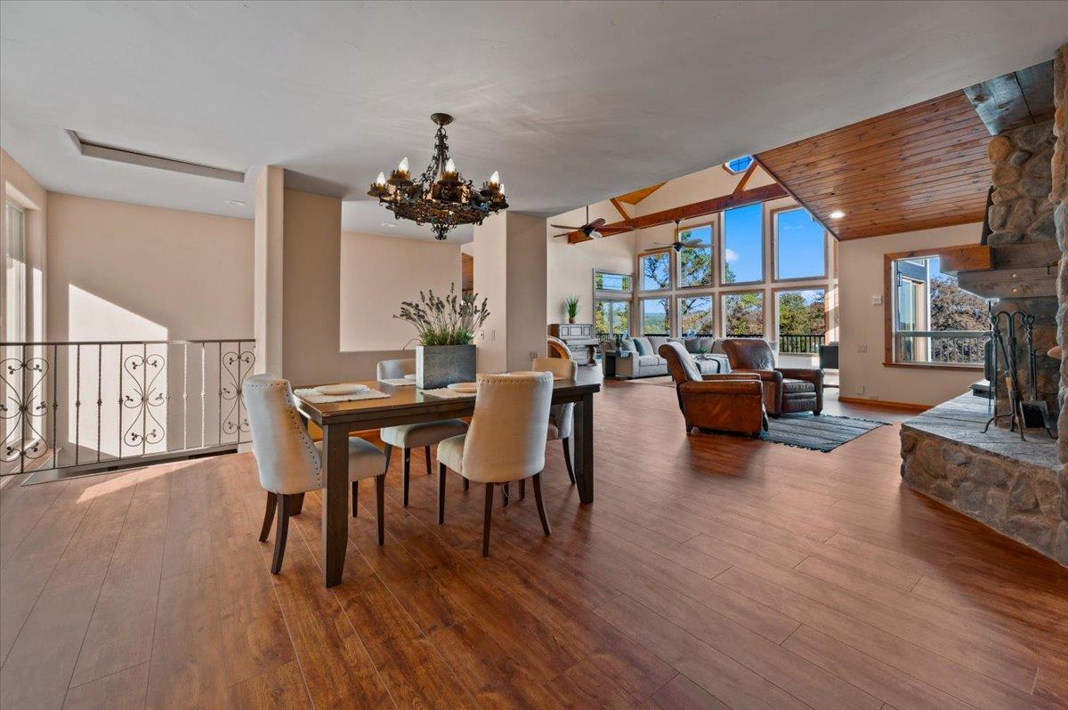 16000 Southridge Road Penn Valley, CA 95946 - Photo 26 of 75 a dining room with furniture a chandelier and wooden floor