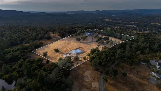 a living room with furniture a large window and wooden floor