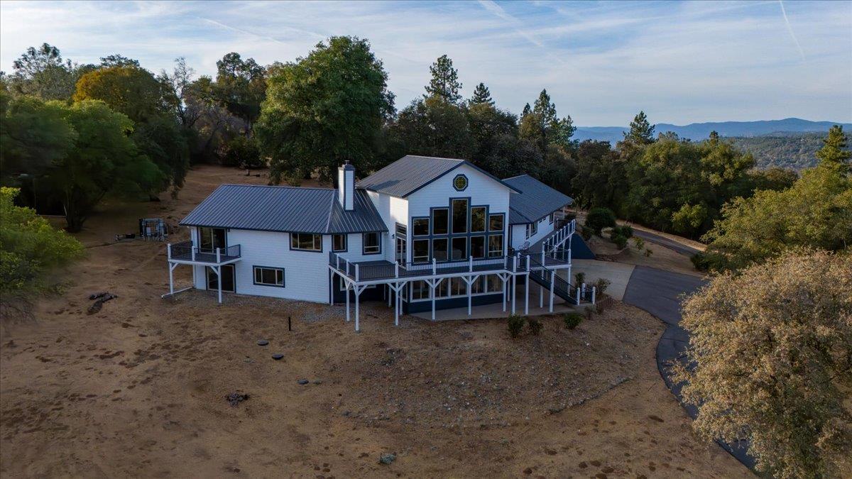 16000 Southridge Road Penn Valley, CA 95946 - Photo 65 of 75 an aerial view of a house with yard and trees in the background