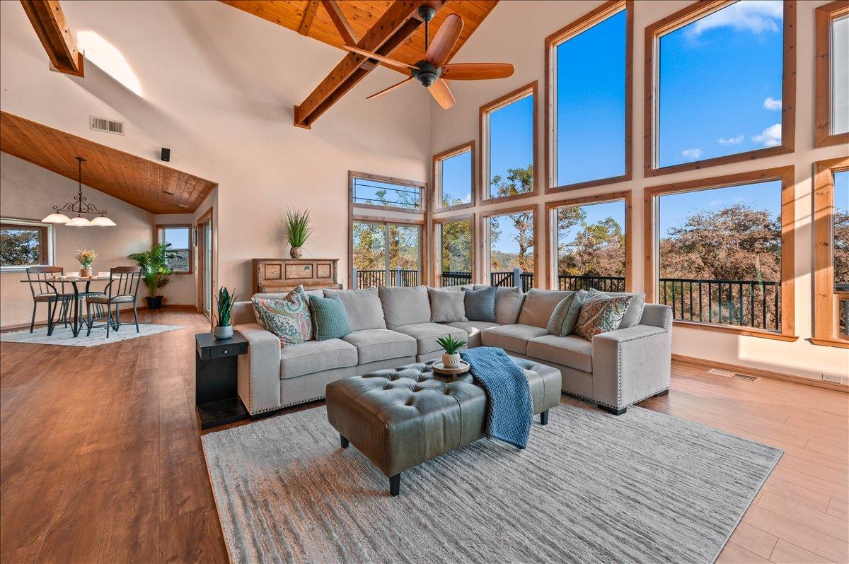 16000 Southridge Road Penn Valley, CA 95946 - Photo 8 of 75 a living room with furniture a large window and wooden floor